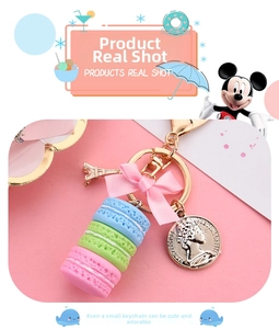 Detailed view of 3-layer macaron keychain with pink bow and Eiffel Tower charm