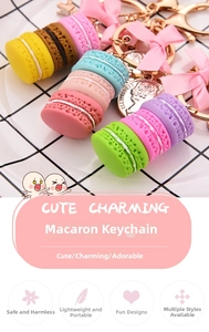 Close-up of colorful macaron keychain with pink bow and golden Eiffel Tower charm