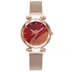 Detail of rose gold mesh watch band and red dial featuring a rhinestone swan pattern