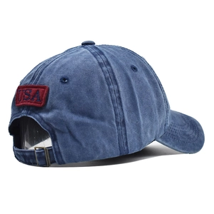 Detail of washed denim baseball cap with USA embroidery and adjustable metal buckle