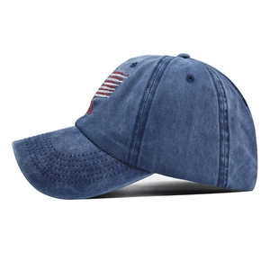 Vintage washed blue cotton baseball cap with American flag embroidery from a side view