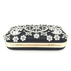 Detail of handcrafted floral bead embroidery and crystals on black evening clutch bag