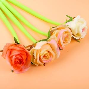 Detailed view of rose-shaped gel pens in pink and orange tones with green leaf stems