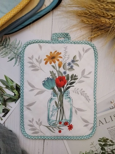 Thick cotton pot holder with floral print, blue checkered border, and hanging loop detail