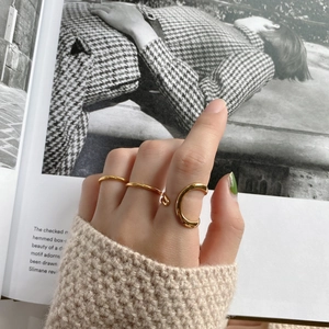 Minimalist 925 sterling silver gold rings shown on hand with knitted sweater backdrop