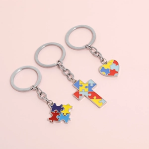 Colorful autism awareness puzzle heart and cross keychains in vibrant enamel finish