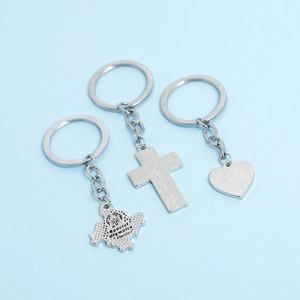 Detail of silver metal keychains with heart, cross, and Special Olympics Florida charms