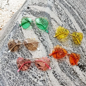 Kids daisy flower aviator sunglasses in five vibrant colors on stone background