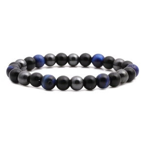 Detail of blue tiger eye and black obsidian beaded bracelet on a clean white background