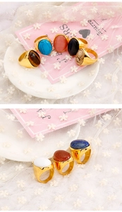 Macro view of vintage oval stone rings with turquoise and opal in gold settings