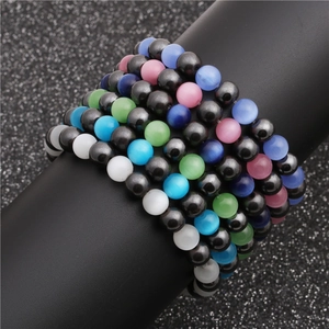 Detail of beaded bracelets with tiger eye stones and hematite on a display stand