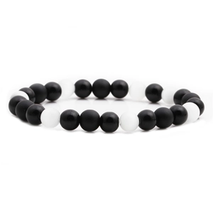 Handmade beaded bracelet with matte black onyx and white opal stone beads on white background