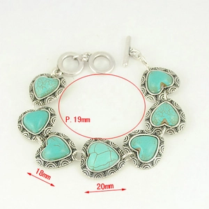 Macro view showing dimensions of heart-shaped turquoise stones on bohemian silver bracelet