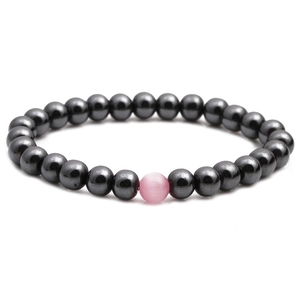 Hematite beaded bracelet featuring a pink cat eye stone on a clean white background