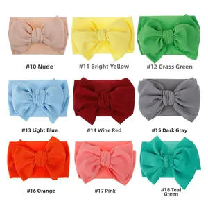 Set of 9 soft waffle texture baby headbands with large bows in multiple pastel colors
