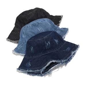 Detailed close-up of distressed denim bucket hats with frayed edges in three vintage colors