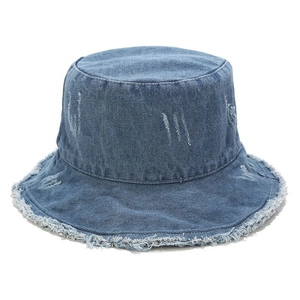 Detail of frayed edges and distressed texture on a vintage blue denim bucket hat