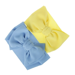 Detail of light blue and yellow waffle knit fabric baby bow headbands for infants