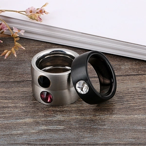 Minimalist brushed stainless steel rings with zircon stones on a wooden background