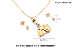 Detail view of gold stainless steel bird pendant necklace and stud earrings set with sizes