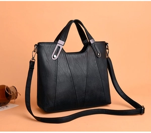 Detailansicht der schwarzen Kunstledertasche mit V-Nähten und gunmetal Beschlägen