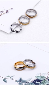 Macro detail of mixed gold and silver stainless steel rings with braided texture