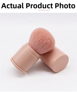 Close-up of portable retractable blush brush with dense bristles and protective cap