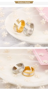 Detail of 18k plated open rings with shell inlay and micro-pave crystals on lace background