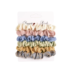 Detail of 6-piece velvet scrunchie set in assorted pastel colors on white card