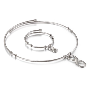Silver infinity symbol jewelry set with cable wire necklace and bracelet on white background