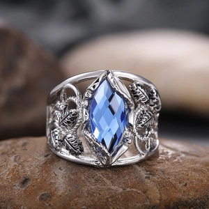 Macro shot of marquise-cut blue crystal ring with vintage hollow leaf silver band