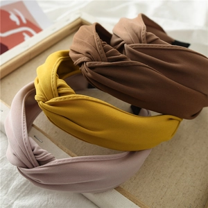 Detail of ribbed knit fabric texture and hand-knotted design on three colorful headbands