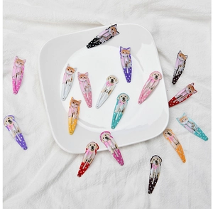 Detailed view of colorful polka dot hair clips with cute cartoon cat and dog patterns