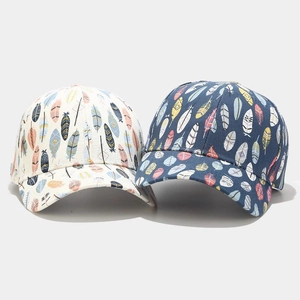 Detail shot of high-quality cotton baseball caps with colorful feather print patterns