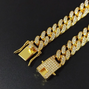 Macro detail of 18K gold plated Cuban link bracelet with iced out diamond clasp mechanism