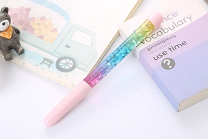Detail of creative glitter liquid sand pen with pink cap and colorful gradient body
