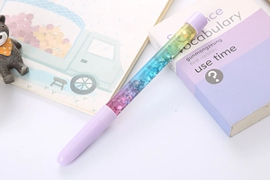 Detail of creative quicksand pen showing purple and blue gradient glitter in liquid barrel