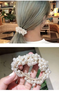 Close-up of vintage pearl hair scrunchie showing glossy bead texture and elastic band