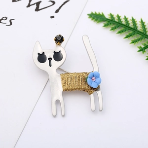 Detail of cute cat brooch with gold wire wrap, blue flower, and black rhinestone eye