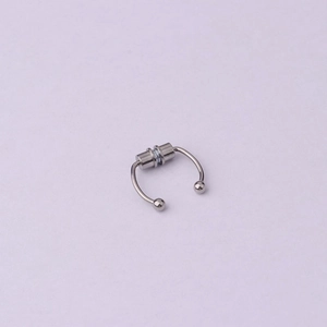 Polished silver magnetic non-piercing septum nose ring on lavender background