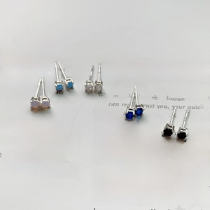 Macro shot of 925 sterling silver stud earrings set with five colorful round gemstones