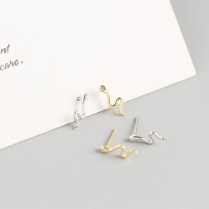 Macro shot of minimalist S925 sterling silver snake earrings with tiny cubic zirconia stones