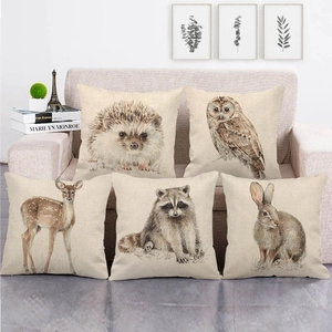 Detailed view of five square linen pillow covers featuring watercolor forest animal patterns