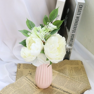Artificial white peony bouquet in pink ceramic vase for wedding and home decoration