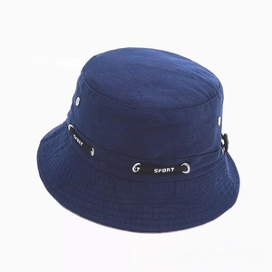 Detail of navy blue cotton bucket hat featuring a decorative sport logo ribbon band