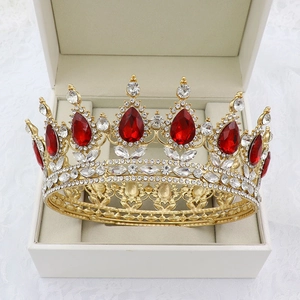 Detailed view of a gold bridal crown with red teardrop stones in a jewelry box