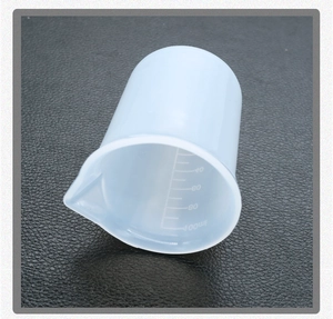 Detailed macro view of 100ml silicone measuring cup with precise black scale markings