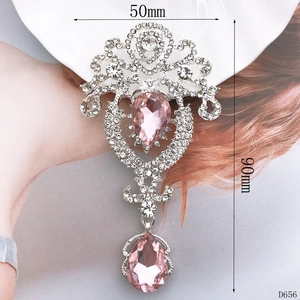 Macro view of silver vintage crown pendant with pink gemstone and rhinestones on model