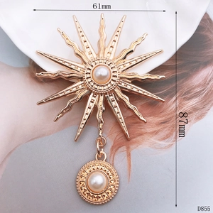 Detailed view of sun-shaped golden pendant with pearls and size labels 61mm by 87mm