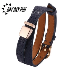 Detail of navy blue double-wrap leather bracelet with rose gold magnetic horseshoe clasp